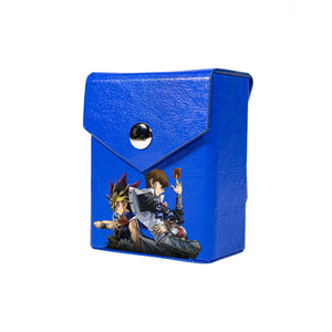 Enhance your TCG storage with the Mach 2 Blue deck box, available in options for 60 or 80 single-card sleeves. Crafted from durable faux leather, it includes a built-in belt loop, a strong magnetic snap, and showcases our exclusive 25th Anniversary Tin: Dueling Mirrors design—ideal for TCG enthusiasts on the move! yugioh-custom-deck-portable-collector-LDB-Duel-blue